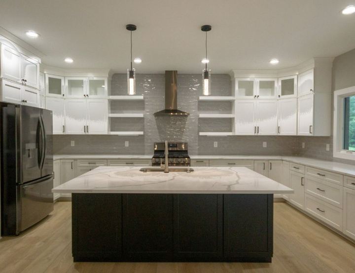 White kitchen with gray glazed subway tile backsplash run to the ceiling, open shelving and quartz island in Avon, IN