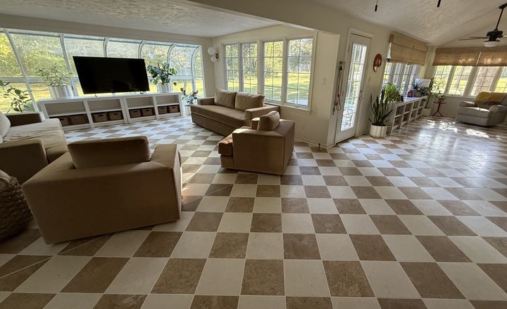 Wide view of a sunroom with diagonal tan and cream checkerboard tile flooring in Brownsburg, IN