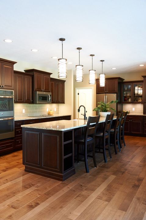 Cherry cabinet kitchen with granite island and maple hardwood flooring in Plainfield, IN