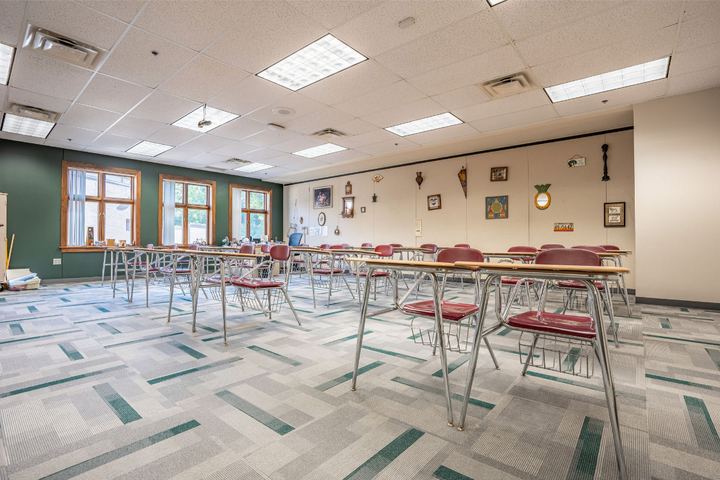 Commercial carpet tile in gray and teal geometric pattern installed in a school classroom in Indianapolis, IN