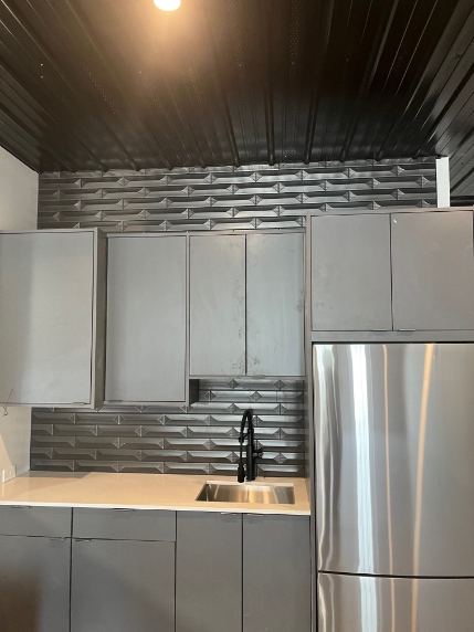 Gray kitchenette with dimensional 3D metallic tile backsplash, black ceiling and matte black faucet in Westfield, IN