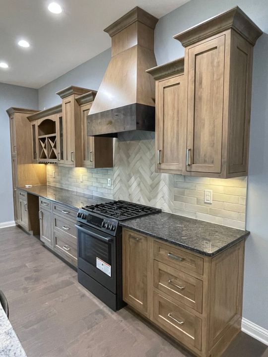 Kitchen backsplash with brick-look subway tile and herringbone accent behind the range in Plainfield, IN