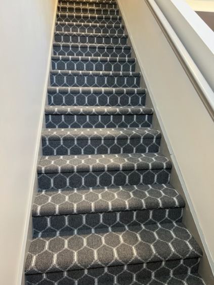 Charcoal honeycomb-pattern carpet installed on a straight staircase in Westfield, IN