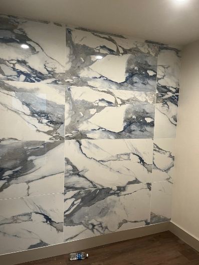 Blue and white marble-look large-format tile accent wall in an office break room in Indianapolis, IN