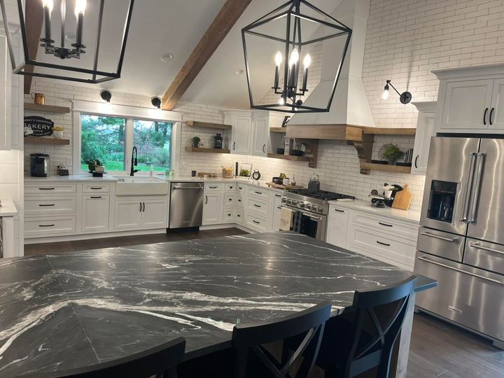 Farmhouse kitchen with white subway tile run to the ceiling, soapstone island and open wood shelving in Pittsboro, IN