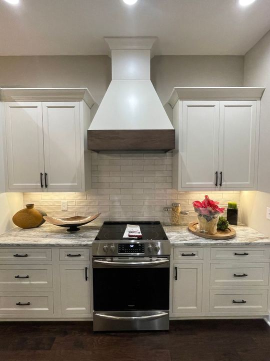 White kitchen with handmade-look subway tile backsplash and granite countertops in Plainfield, IN